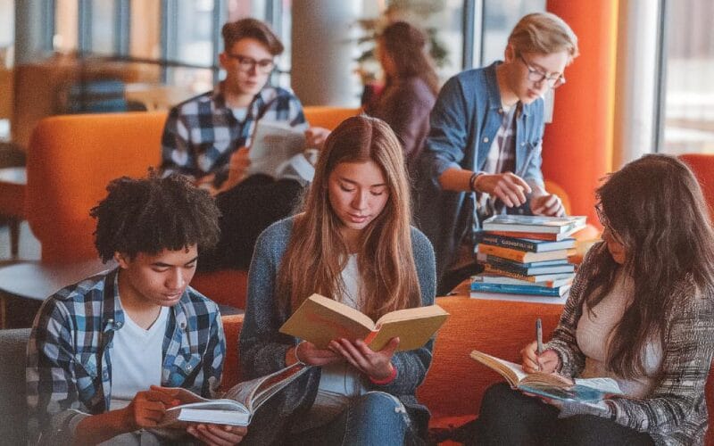 A group of young adults reading and engaging with literature
